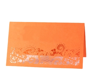 Elegant laser-cut lace place card in orange for wedding and party table setting