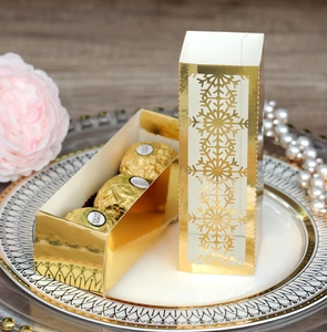 Elegant gold hollow snowflake candy gift box for wedding parties on a white plate