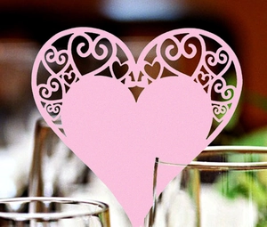 Pink heart-shaped laser-cut place cards for wedding decorations and party table settings