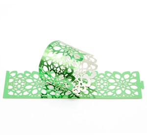 Elegant emerald green metallic laser-cut napkin ring with intricate floral patterns