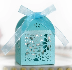 Elegant sky blue laser-cut floral favor box with a satin ribbon for weddings