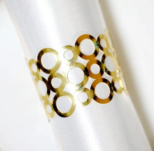 Elegant gold reflective napkin ring with circular hollow design for wedding table decor