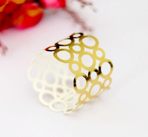 Elegant reflective gold hollowed napkin ring with modern layered circular geometric design