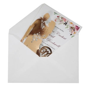 Elegant laser-cut wedding invitation set with gold foil silhouette and floral details