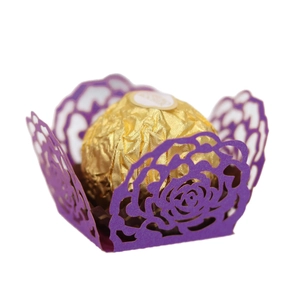 Purple laser-cut hollow rose lace candy box with chocolate on a white background
