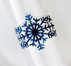 Deep blue snowflake metal napkin ring with hollow design on white satin cloth