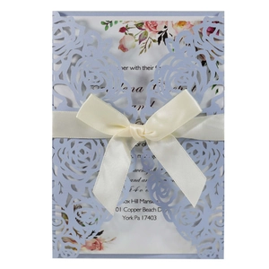 Laser cut blue rose wedding invitation with cream ribbon bow and floral inner card