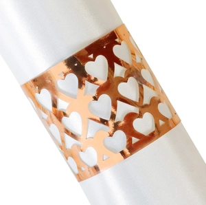 Elegant rose gold hollow heart paper napkin ring on a white satin cloth for weddings