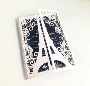 Laser-cut Eiffel Tower wedding invitation set with white outer shell and navy inner card