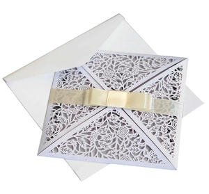 Laser cut floral wedding invitation set with cream ribbon and white envelope