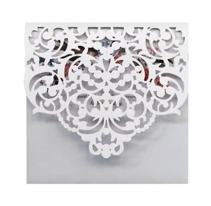 European laser-cut wedding invitation with intricate floral lace and floral inner card