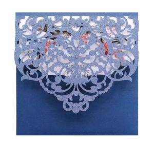 Laser cut navy blue glitter wedding invitation with intricate floral hollow out design