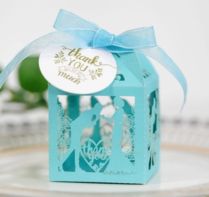 Laser-cut Tiffany blue candy box with romantic silhouette and elegant ribbon bow