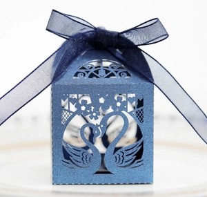 Blue laser-cut swan heart candy box with glitter finish and dark blue ribbon bow