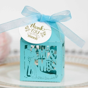 Light blue laser-cut wedding favor box with Mr & Mrs design and thank you tag
