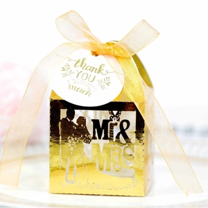 Golden mirror finish laser-cut MR & MRS wedding favor box with a ribbon and tag