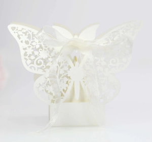 Elegant pearl white laser-cut butterfly wedding favor box with matching satin ribbon