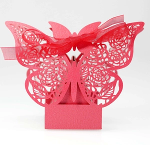 Elegant red laser-cut butterfly candy box with rose patterns and a red silk ribbon bow
