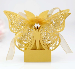 Golden laser-cut butterfly candy box with rose patterns and matching silk ribbon