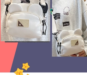 Detail of white bear ear crossbody bag with logo patch and adjustable wide strap