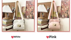 Detail of cute bear-eared canvas crossbody bags in pink and white with leather patch