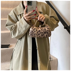 Detail of leopard print evening clutch with gold ring handle and luxury jewel closure