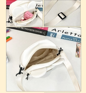 Detail view of white canvas crossbody bag with cute bunny ears and multi-layer inner pockets