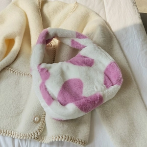 Close-up of pink cow print faux fur tote bag showing soft plush texture and single handle