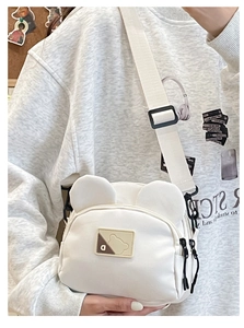 Detailed view of white cartoon bear canvas bag with cute ears and adjustable strap