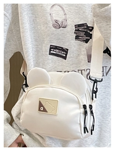 Detail of cute white canvas shoulder bag with 3D bear ears and adjustable wide strap