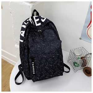 Close-up of black backpack with colorful star patterns and white decorative lettering