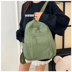 Waterproof nylon backpack in forest green showing side view with comfortable straps