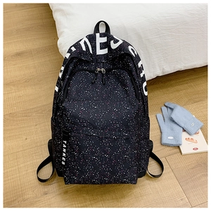 Close-up of the black canvas starry backpack with white letter print and logo strap