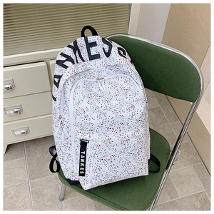 Detailed view of TANKES splash pattern canvas backpack on a green chair in home setting