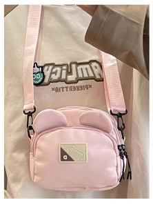 Detail view of cute pink teddy bear canvas crossbody bag with 3D ears and adjustable strap