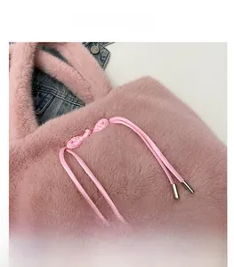 Close-up of pink faux fur tote bag showing soft plush texture and woven rope detail
