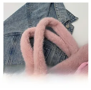 Close-up of pink plush tote bag with soft handles and elegant satin knot detail