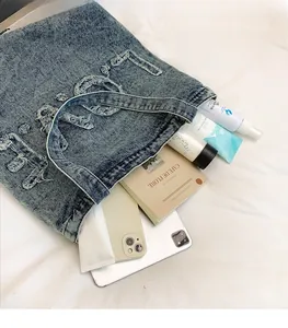 Internal view showing large capacity for books and iPad in washed denim tote bag