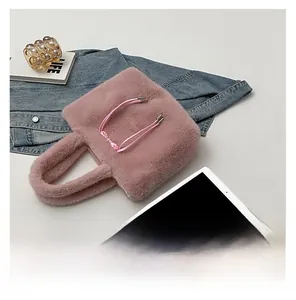 Detail of pink plush tote bag showing soft faux fur texture and matching fuzzy handles