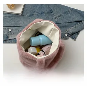 Macro view of the large capacity pink plush tote bag showing spacious interior and items