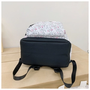 Detail view of the durable black base and modern speckled print fabric on this backpack