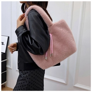 Detail showing the plush pink faux fur texture and drawstring of this large tote bag