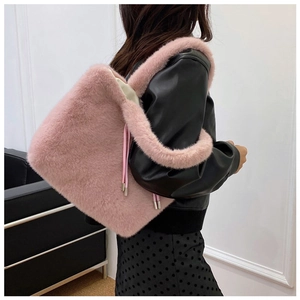 Detailed close-up of a pink plush tote bag featuring soft faux fur and drawstring details
