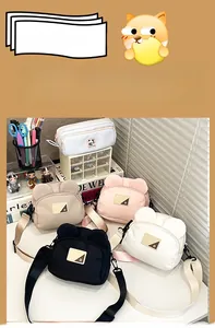 Close-up of cute cartoon bear canvas shoulder bags and matching pencil cases on a desk