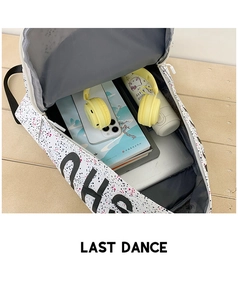 Detailed top view of the spacious white star pattern backpack showing laptop storage space