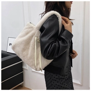 Chic cream-colored faux fur bucket bag shown with leather drawstrings and soft texture