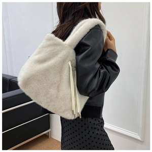 Detail of off-white faux fur tote bag with long plush texture and drawstring tassels