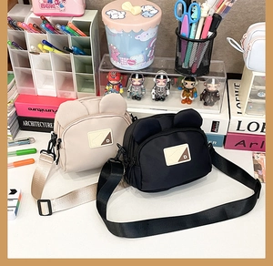 Detail of cute bear crossbody bags with animal ears and adjustable straps