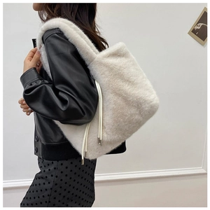 Detail of white plush tote bag with drawstring tassels and soft faux fur texture
