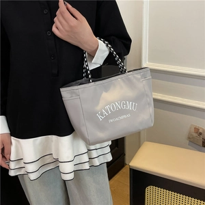 Light gray large capacity tote bag with striped handles and white letter printing
